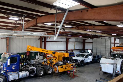 ACME Precision Diesel shop floor in Greer with a semi tractor, a crane, and service trucks in the bays